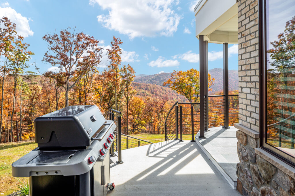 Outdoor grill on the deck with mountain and forest views at The Vale luxury cabin in Lost River West Virginia