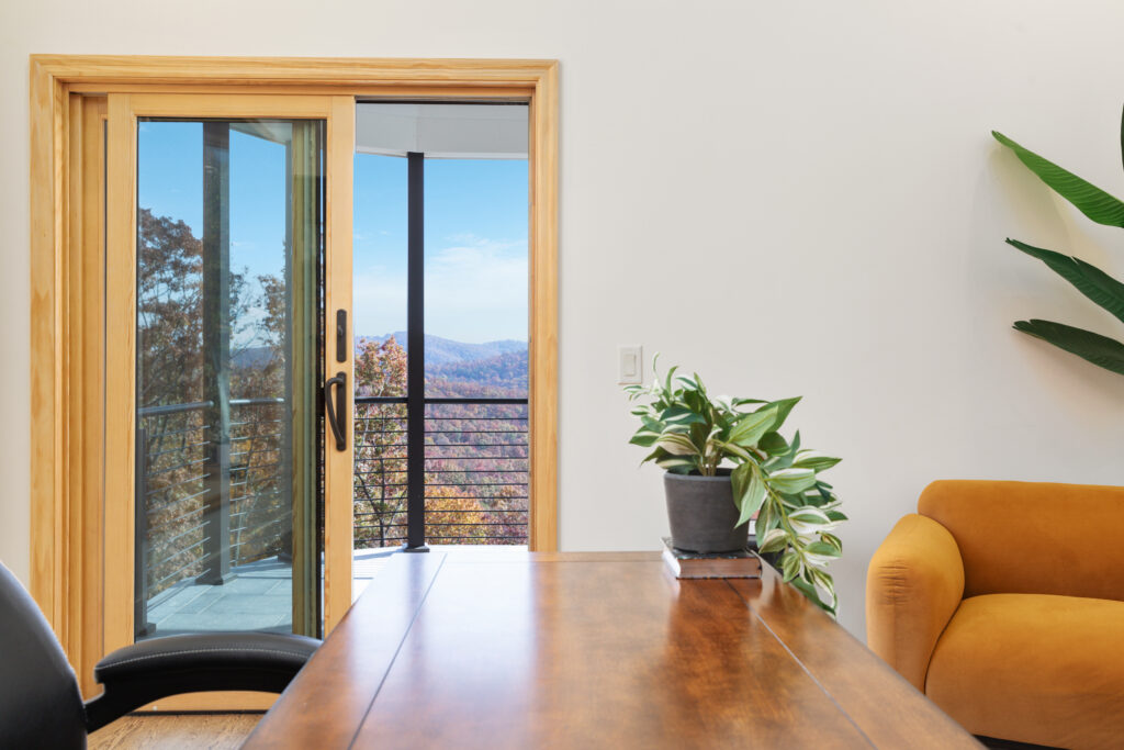 Home office with desk and balcony mountain view at The Vale luxury cabin in Lost River West Virginia