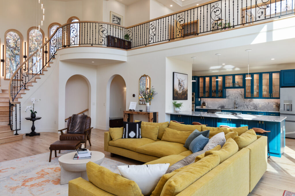 Open concept living room and luxury kitchen with the loft and round staircase at The Vale in Lost River, West Virginia