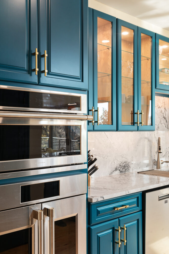 Luxury stainless steel appliances and custom blue cabinetry in the kitchen at The Vale in Lost River West Virginia