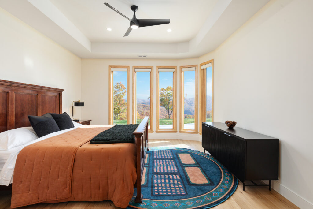 Spacious bedroom with panoramic mountain views at The Vale luxury cabin in Lost River West Virginia