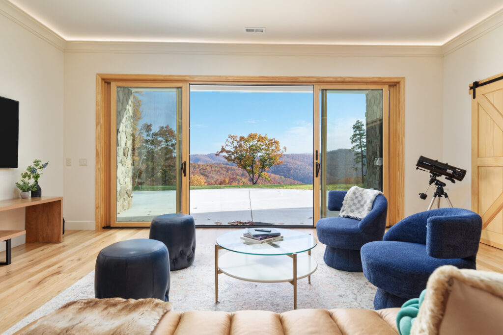 Downstairs living room with mountain views at The Vale luxury cabin in Lost River West Virginia