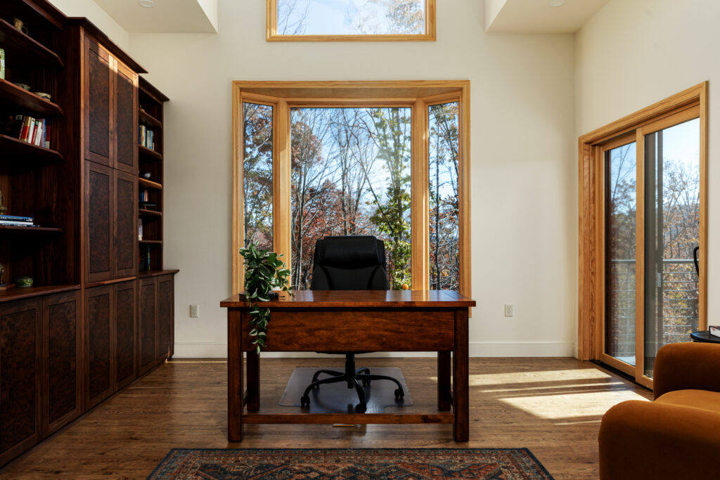 The Vale private office with wooden desk, built-in bookshelves and forest views, Lost River West Virginia