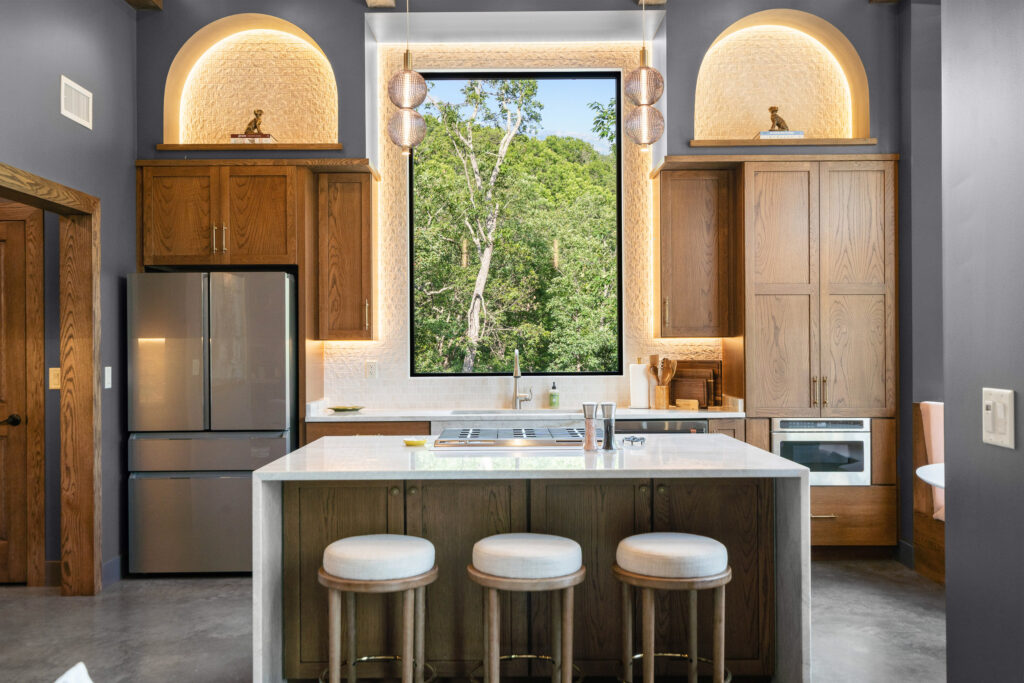 Chef's Kitchen at The Nook with a large picture window above the sink and arches on either side of the window