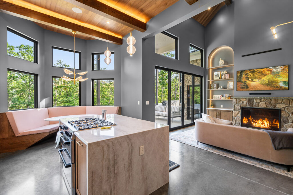Kitchen and dining area with island seating and large windows at The Nook in Lost River, WV