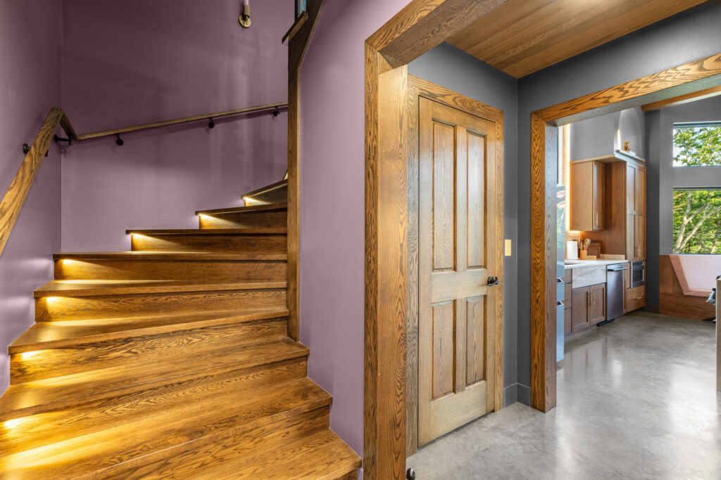 Wood-floored hallway and staircase at The Nook luxury cabin