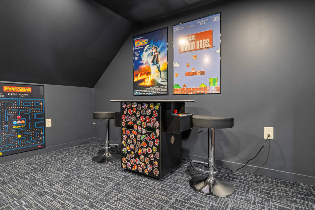 Game room with bar seating and colorful artwork at The Nook luxury rental