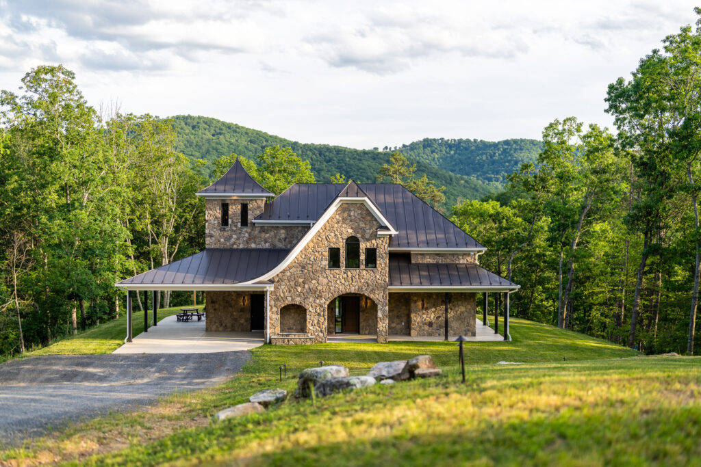Exterior of The Nook with covered entry and mountain backdrop in Lost River, WV