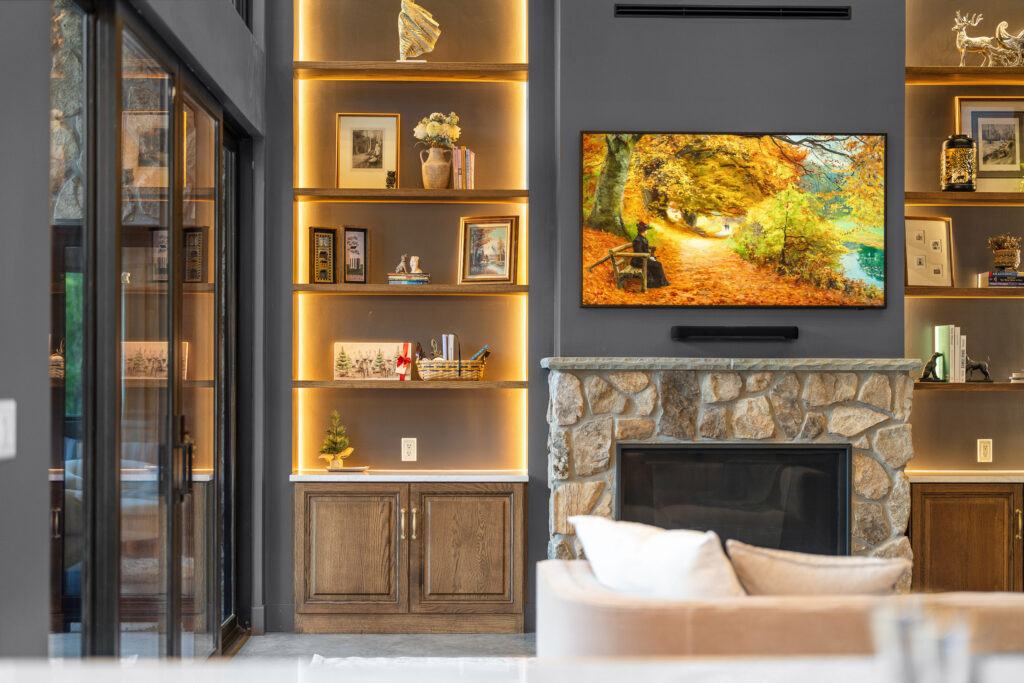 Custom built-in shelving with curated decor and warm accent lighting at The Nook